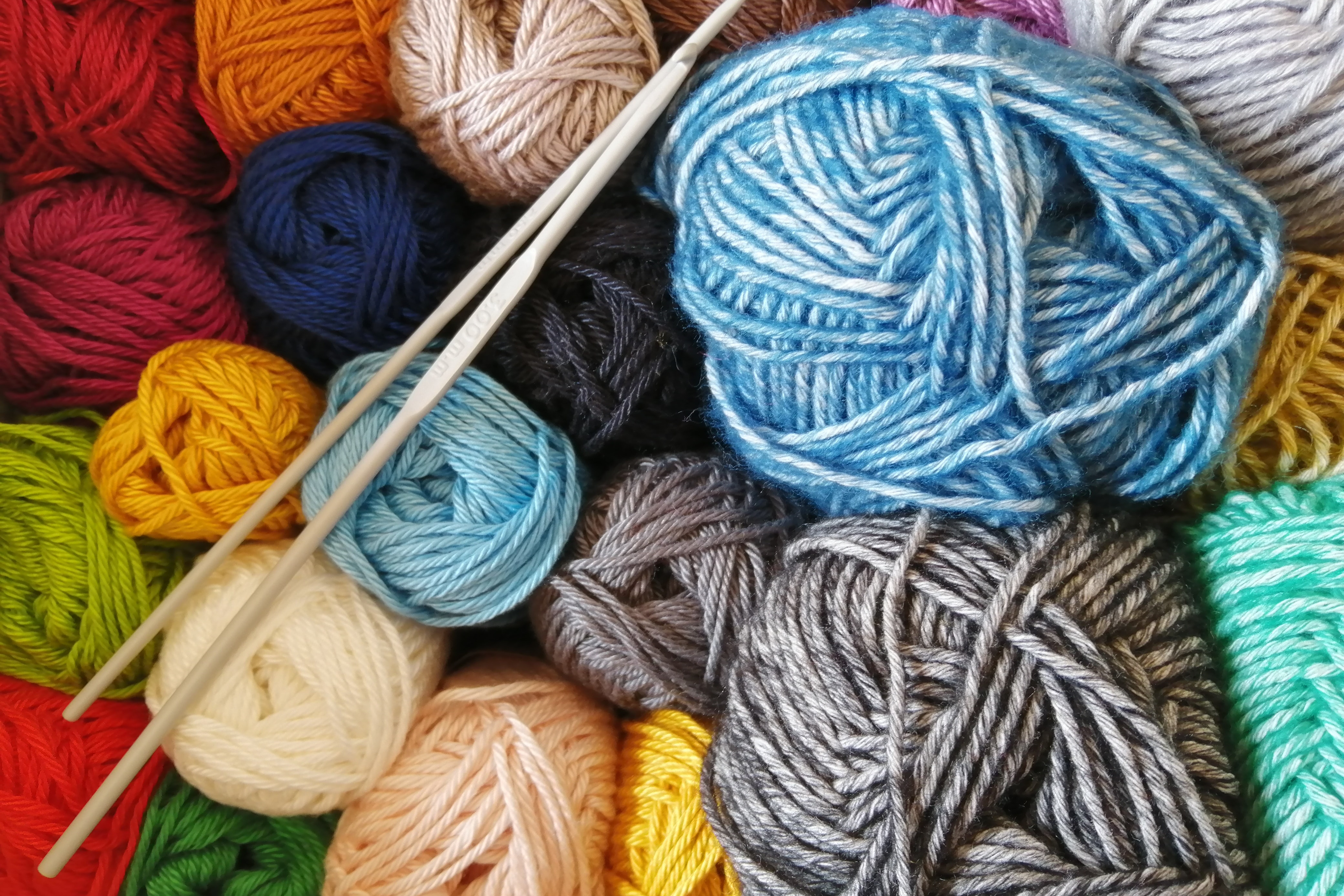 Balls of wool and crochet hooks